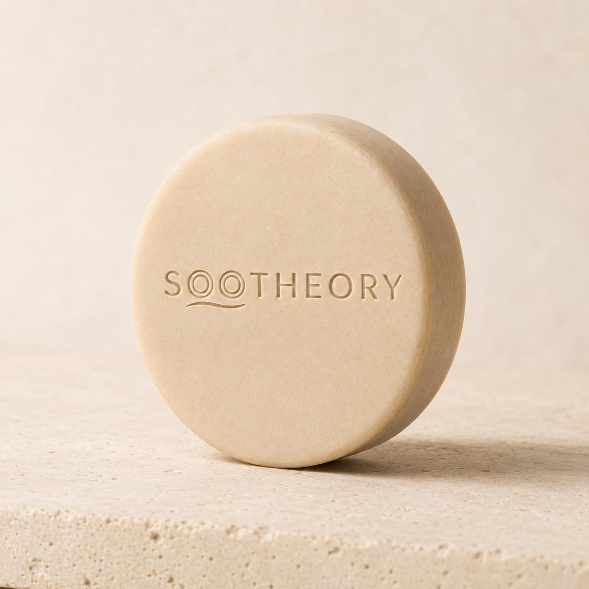 Oatmeal beige dog shampoo bar with embossed SOOTHEORY wave logo
