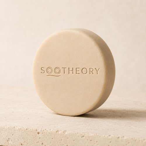 Oatmeal beige dog shampoo bar with embossed SOOTHEORY wave logo