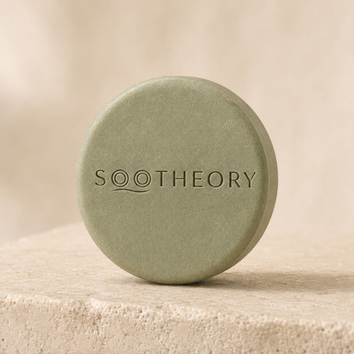 Sage green dog shampoo bar with embossed SOOTHEORY wave logo