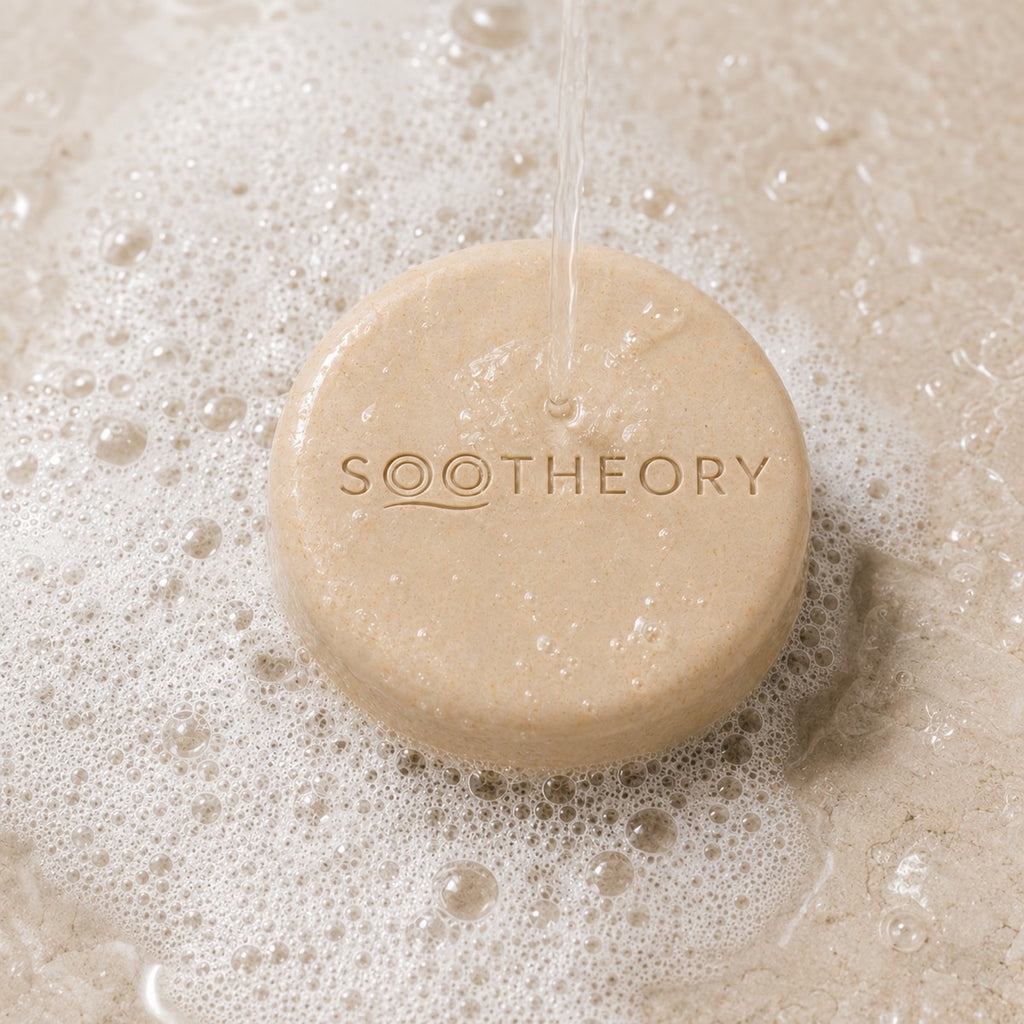 Oatmeal dog shampoo bar under water with rich white lather